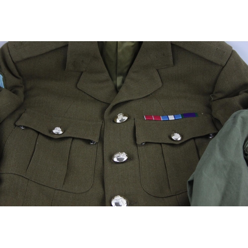 222 - A vintage Paratrooper uniform to include shirts, tunic, trousers, pegasus, belt etc.