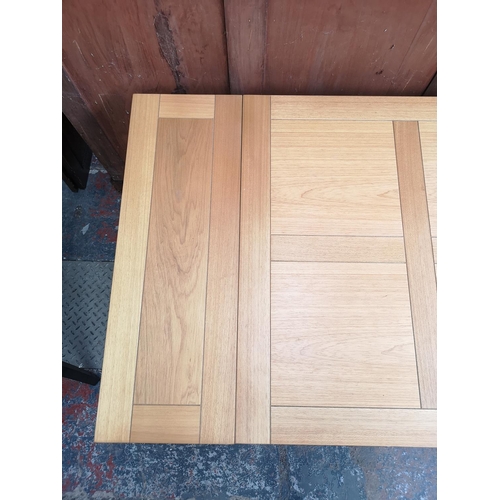 241 - A modern oak effect extending dining table with four matching chairs - approx. 76cm high x 80cm x 80... 