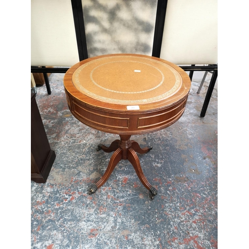 243 - A Regency style mahogany drum table with tan leather insert