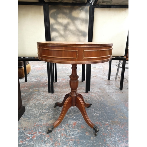 243 - A Regency style mahogany drum table with tan leather insert