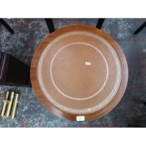 243 - A Regency style mahogany drum table with tan leather insert