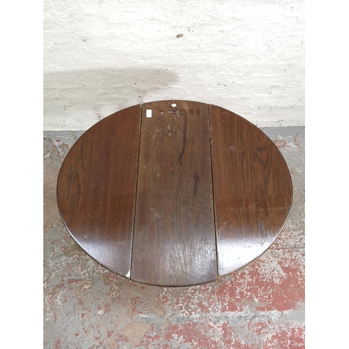 255 - A mid 20th century oak drop leaf occasional table with bobbin turned supports