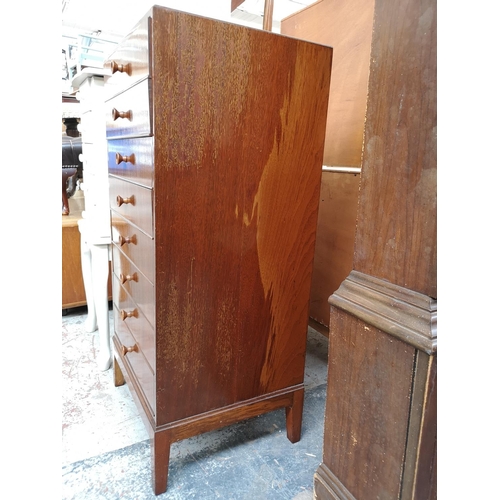 259 - A mid 20th century tola wood eight drawer music cabinet