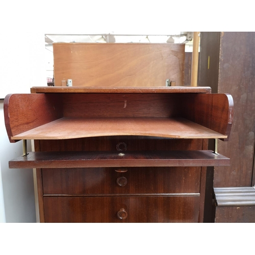 259 - A mid 20th century tola wood eight drawer music cabinet