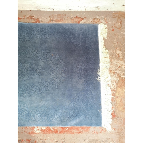 265 - A blue floral patterned rug - approx. 185cm x 125cm