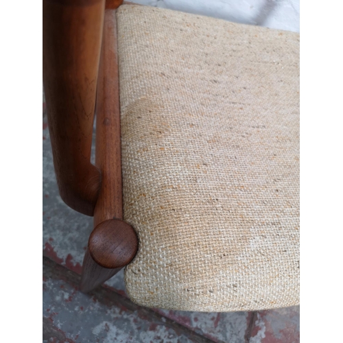 291 - A mid 20th century teak elbow chair