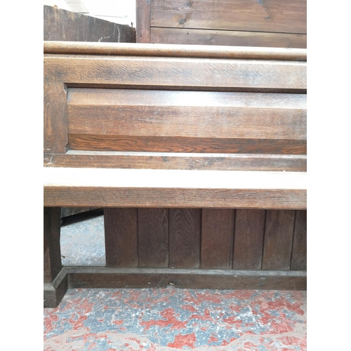 311 - A late 19th/early 20th century solid oak church pew - approx. 91cm high x 145cm wide x 50cm deep