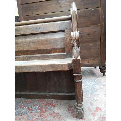 311 - A late 19th/early 20th century solid oak church pew - approx. 91cm high x 145cm wide x 50cm deep