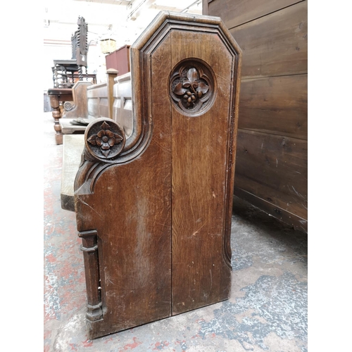 311 - A late 19th/early 20th century solid oak church pew - approx. 91cm high x 145cm wide x 50cm deep