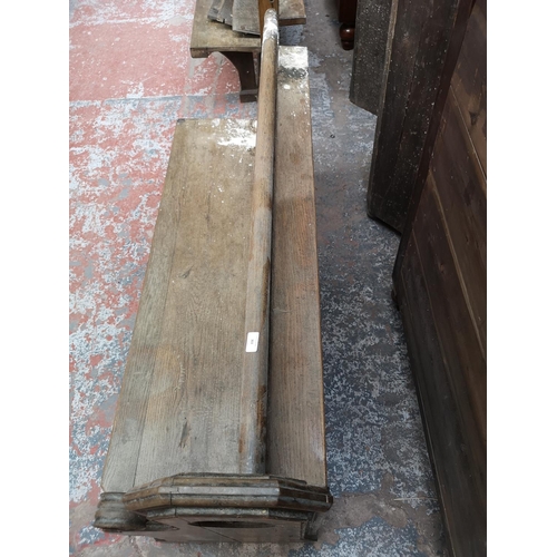 311 - A late 19th/early 20th century solid oak church pew - approx. 91cm high x 145cm wide x 50cm deep