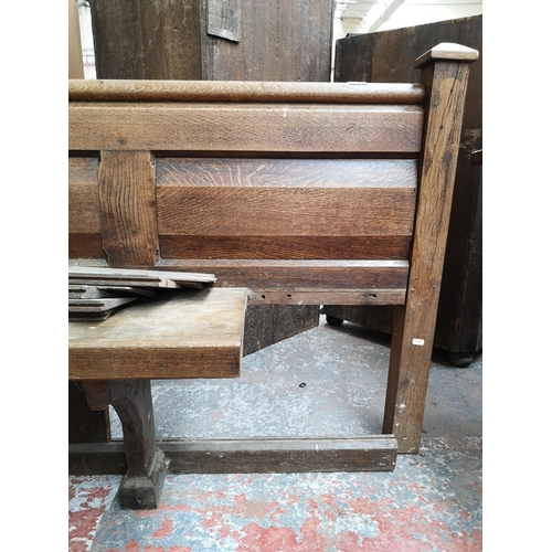 312 - A late 19th/early 20th century solid oak church pew - approx. 90cm high x 175cm wide x 50cm deep