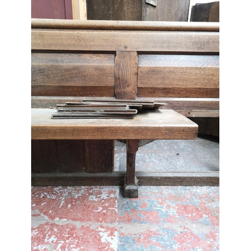 312 - A late 19th/early 20th century solid oak church pew - approx. 90cm high x 175cm wide x 50cm deep