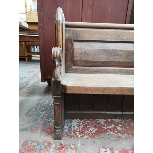 312 - A late 19th/early 20th century solid oak church pew - approx. 90cm high x 175cm wide x 50cm deep