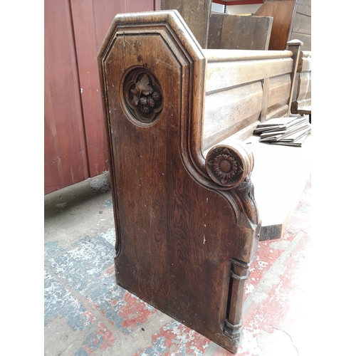 312 - A late 19th/early 20th century solid oak church pew - approx. 90cm high x 175cm wide x 50cm deep