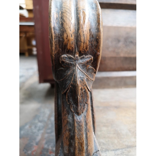 312 - A late 19th/early 20th century solid oak church pew - approx. 90cm high x 175cm wide x 50cm deep