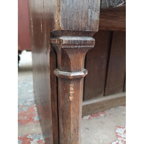 312 - A late 19th/early 20th century solid oak church pew - approx. 90cm high x 175cm wide x 50cm deep