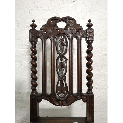 314 - A pair of 19th century heavily carved oak dining chairs with barley twist design