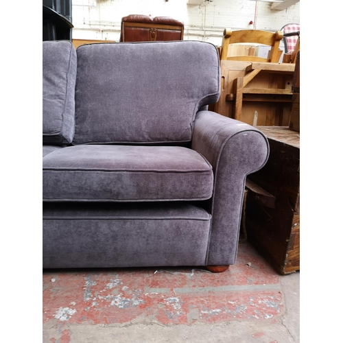 318 - A modern purple upholstered two seater sofa