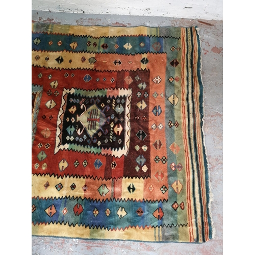 320 - A Persian style multicoloured rug - approx. 230cm x 166cm