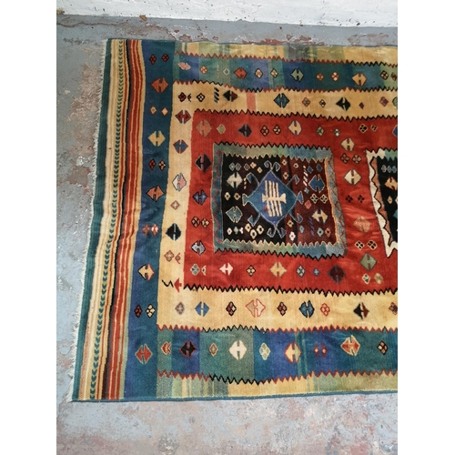 320 - A Persian style multicoloured rug - approx. 230cm x 166cm