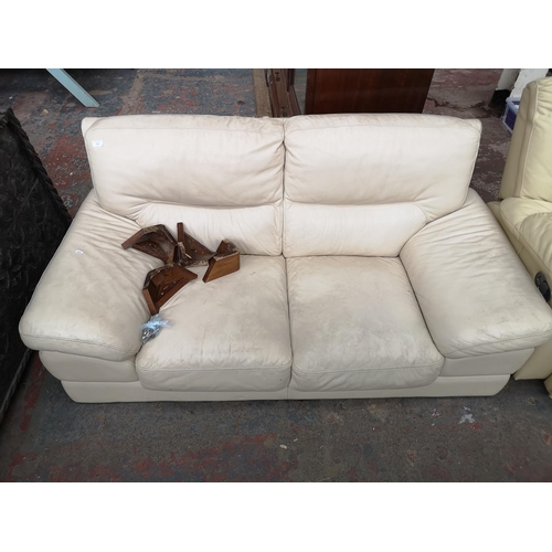 322 - Three items, two cream leather reclining armchairs and one cream leather two seater sofa