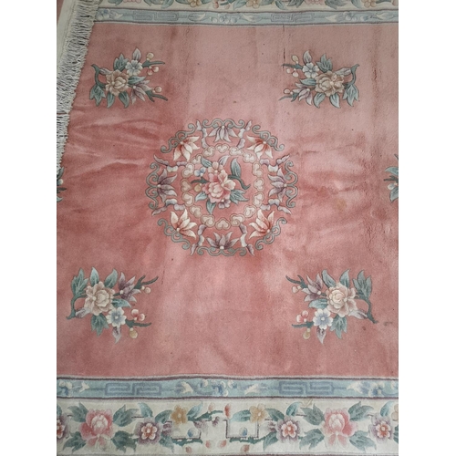 323 - A pink and cream floral patterned rug - approx. 285cm x 180cm