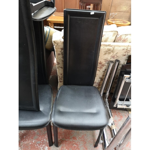 324 - A modern black glass extending dining table and six black leatherette dining chairs