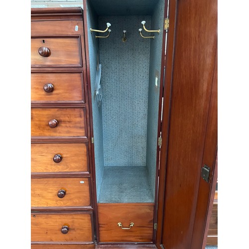 298 - A Victorian mahogany triple wardrobe with two outer panelled doors, two short drawers and five long ... 