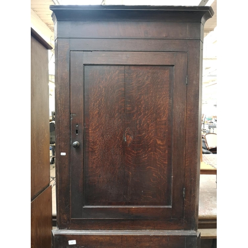 329 - A George III oak freestanding corner cabinet