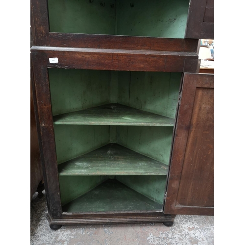 329 - A George III oak freestanding corner cabinet