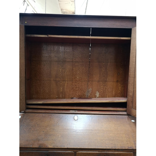 330 - A George III oak bureau bookcase - approx. 220cm high x 122cm wide x 52cm deep