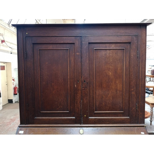 330 - A George III oak bureau bookcase - approx. 220cm high x 122cm wide x 52cm deep