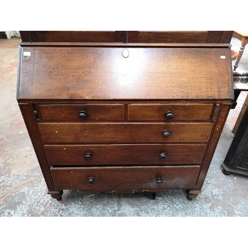 330 - A George III oak bureau bookcase - approx. 220cm high x 122cm wide x 52cm deep