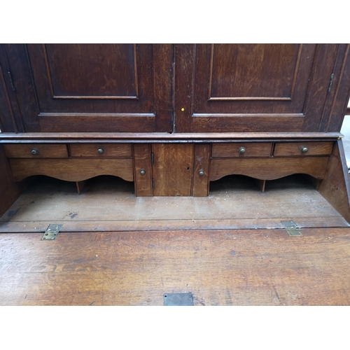 330 - A George III oak bureau bookcase - approx. 220cm high x 122cm wide x 52cm deep