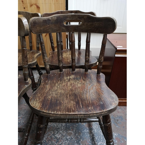 333 - A set of four stained beech spindle back dining chairs