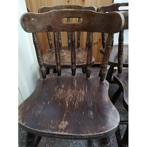 333 - A set of four stained beech spindle back dining chairs