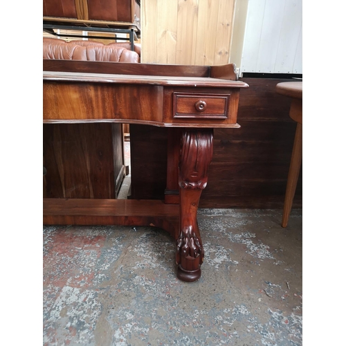 339 - A Victorian mahogany hall table with carved lion paw supports and two drawers