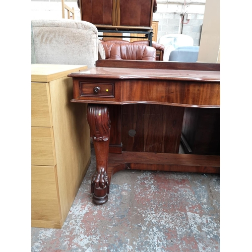 339 - A Victorian mahogany hall table with carved lion paw supports and two drawers