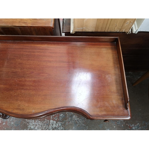 339 - A Victorian mahogany hall table with carved lion paw supports and two drawers