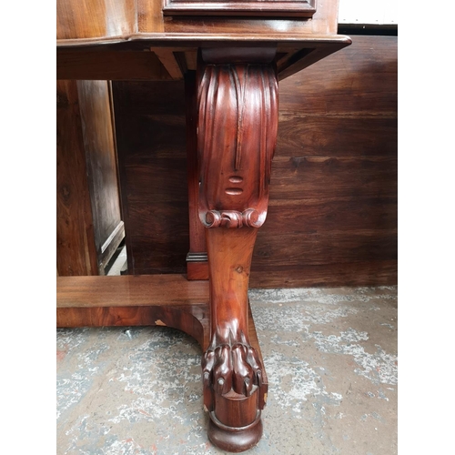 339 - A Victorian mahogany hall table with carved lion paw supports and two drawers