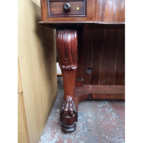 339 - A Victorian mahogany hall table with carved lion paw supports and two drawers