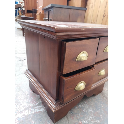 344 - A modern hardwood miniature chest of four drawers with cup shaped handles