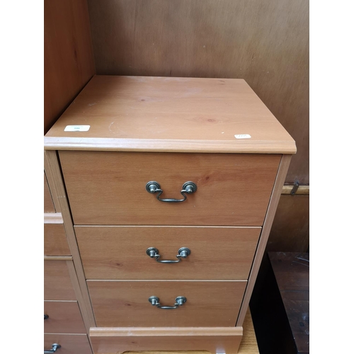 346 - Five pieces of furniture, one pine effect chest of five drawers, three matching bedside cabinets and... 