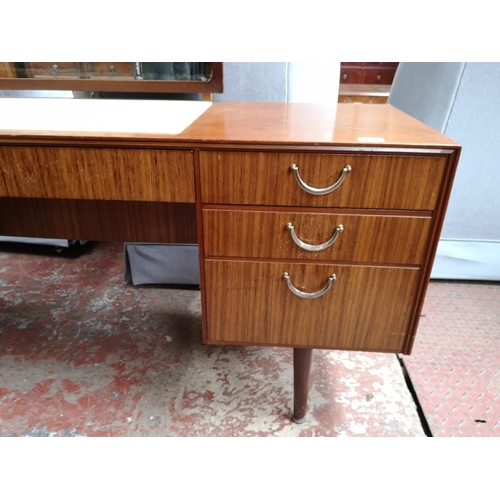 363 - A Meredew teak dressing table with seven drawers and upper mirror