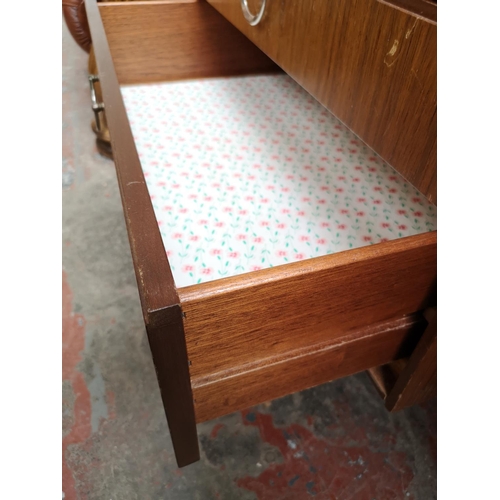 363 - A Meredew teak dressing table with seven drawers and upper mirror