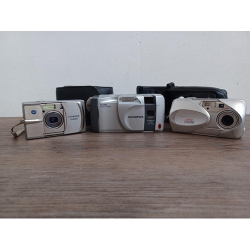 437 - Three digital cameras, one Konica Minolta DiMAGE G600 6mp, one Olympus D-220L and one cased Olympus ... 