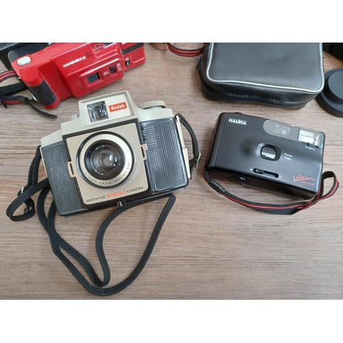 445 - A collection cameras and binoculars to include cased Olympus XA2 35mm compact camera fitted with D.Z... 