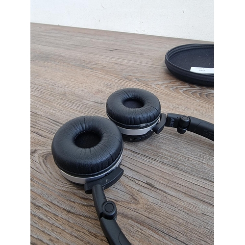 463 - A cased pair of AKG Mercedes Benz folding bluetooth headphones