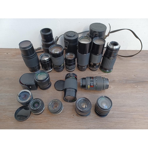 450 - A collection of camera lenses to include Olympus OM system Zuiko, cased Olympus OM system E.Zuiko au... 