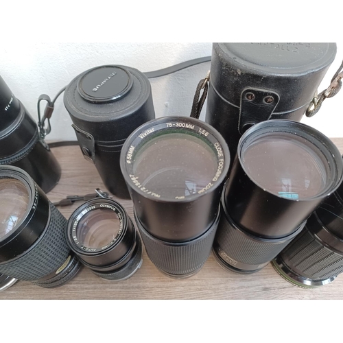 450 - A collection of camera lenses to include Olympus OM system Zuiko, cased Olympus OM system E.Zuiko au... 